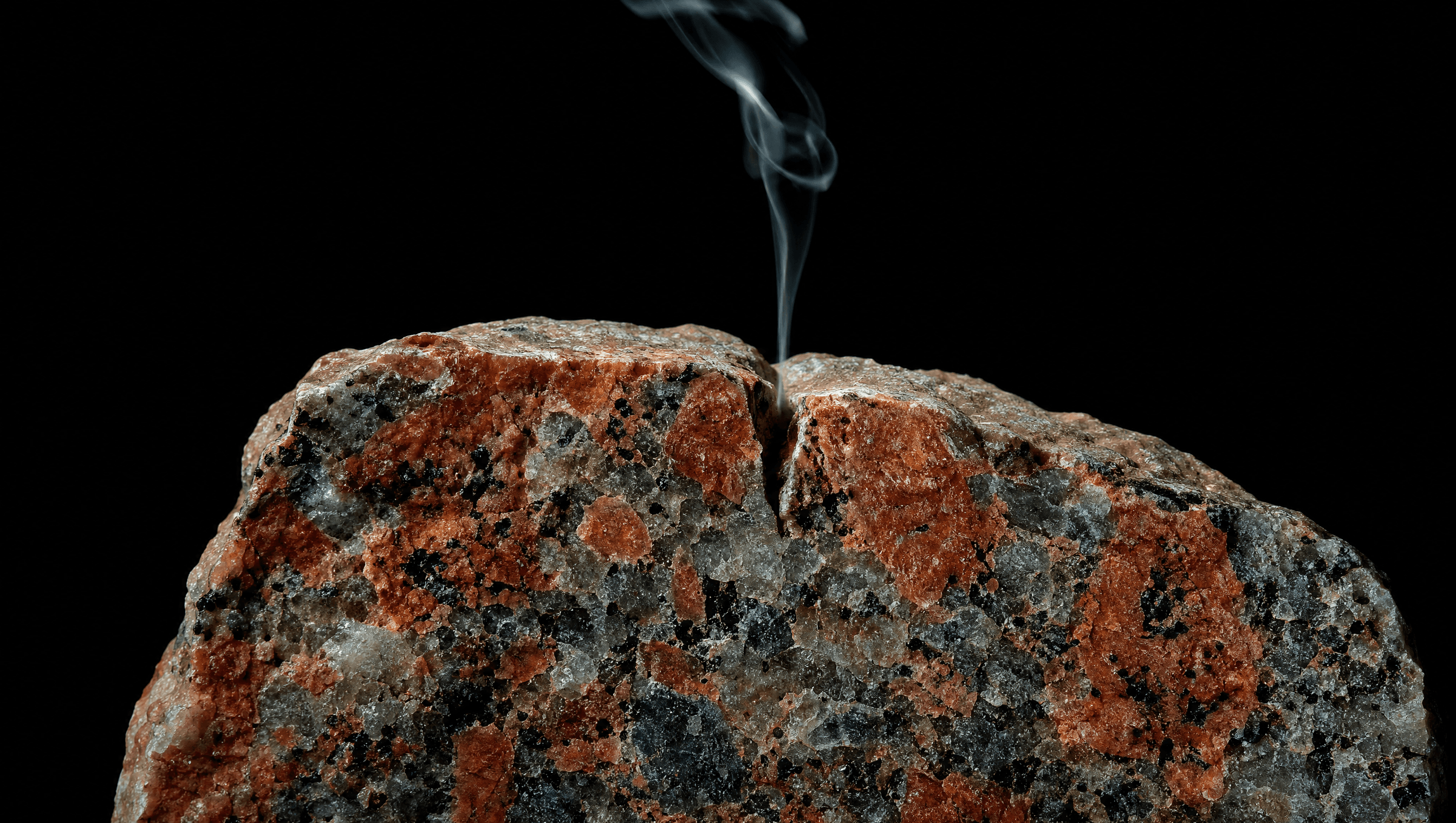 Macro cross-section of Devon granite with vapour rising from a crack